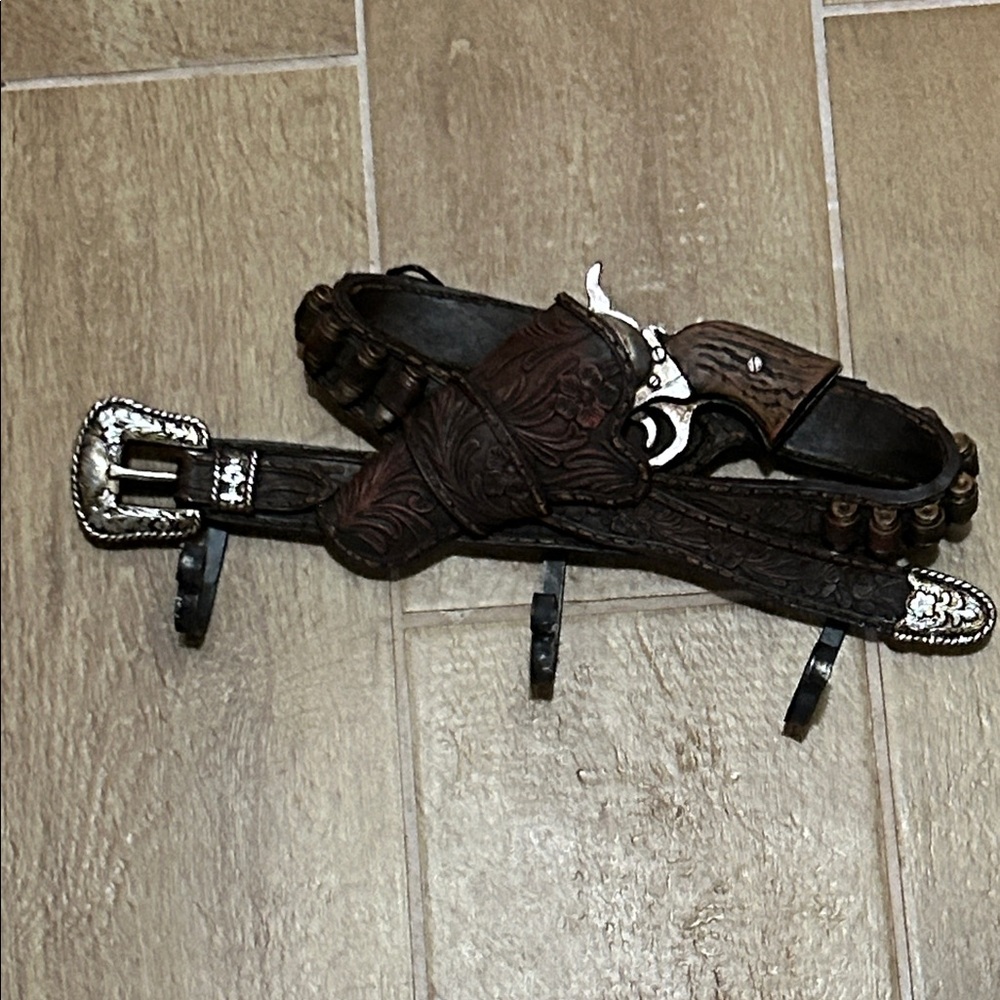 Gun belt wall hanger